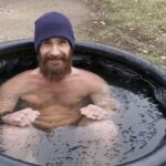 Man doing a controlled cold plunge to support BJJ recovery and reduce inflammation when to cold plunge for recovery