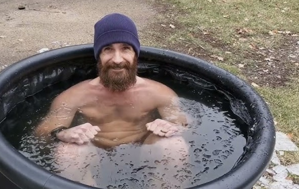 Man doing a controlled cold plunge to support BJJ recovery and reduce inflammation when to cold plunge for recovery
